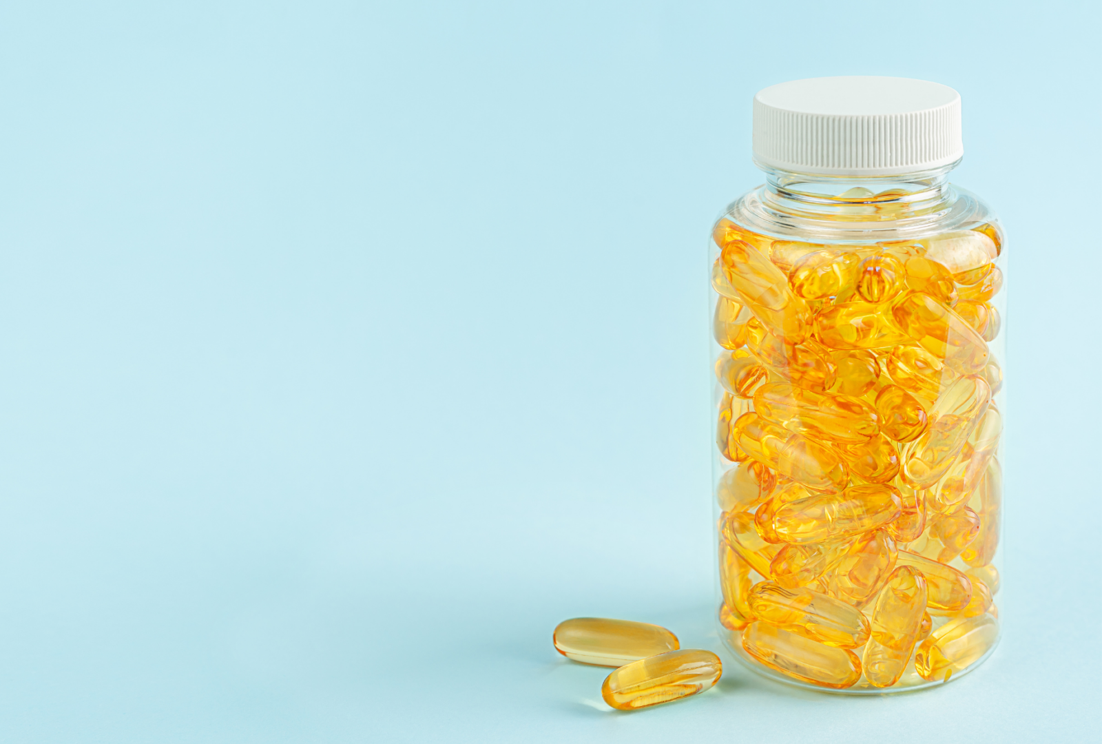 photo of a transparent container with yellow pills