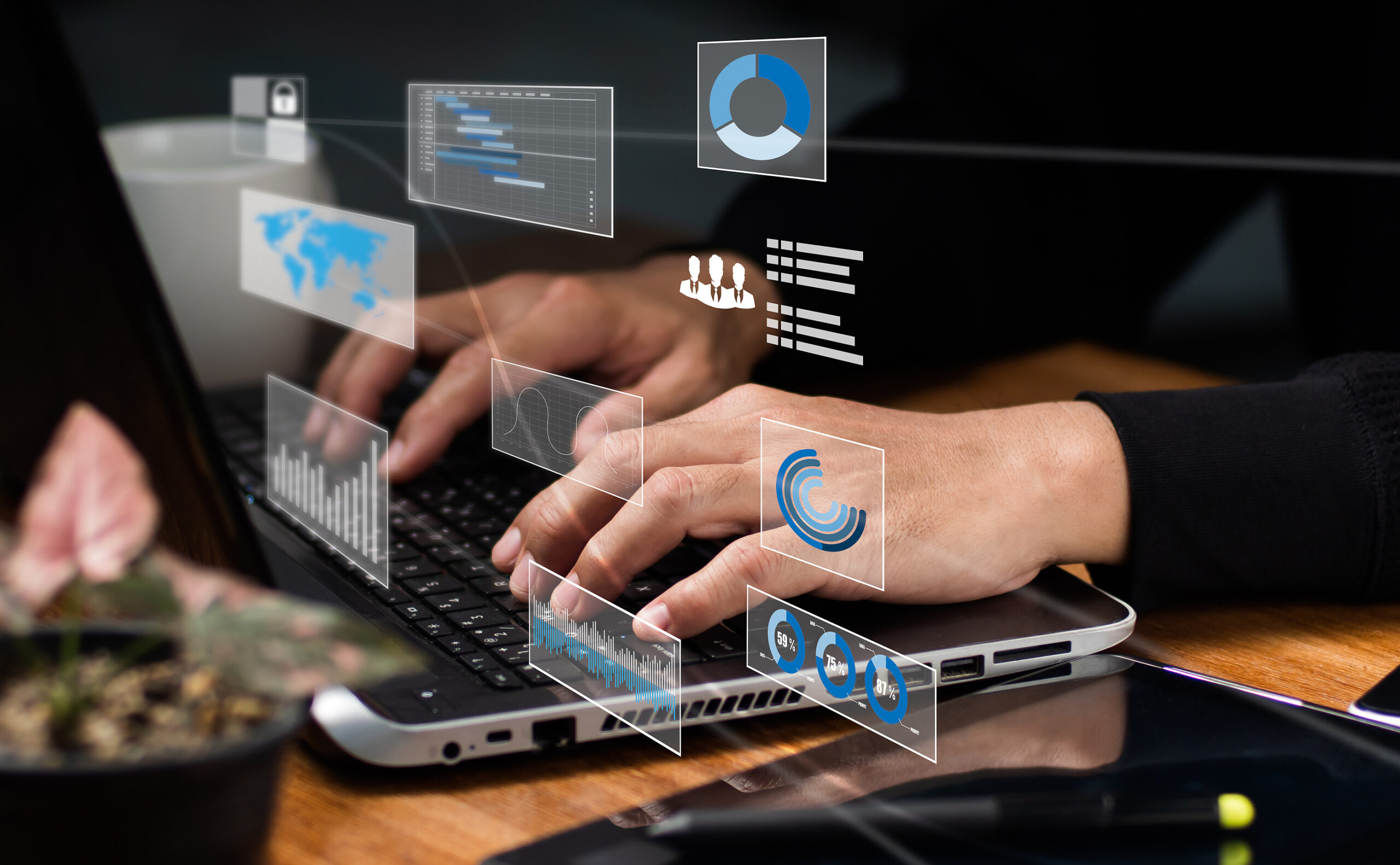 Image of a person typing on a laptop with a graphic overlay of various icons representing AI and technology