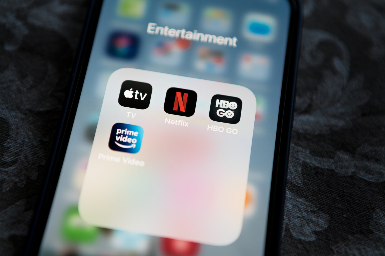 Image of an iphone with the Netflix app and the Prime Video app open on the screen