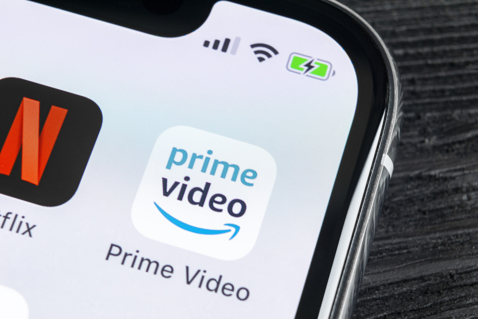 Image of an iphone with the Prime Video app and the Netflix app on the screen