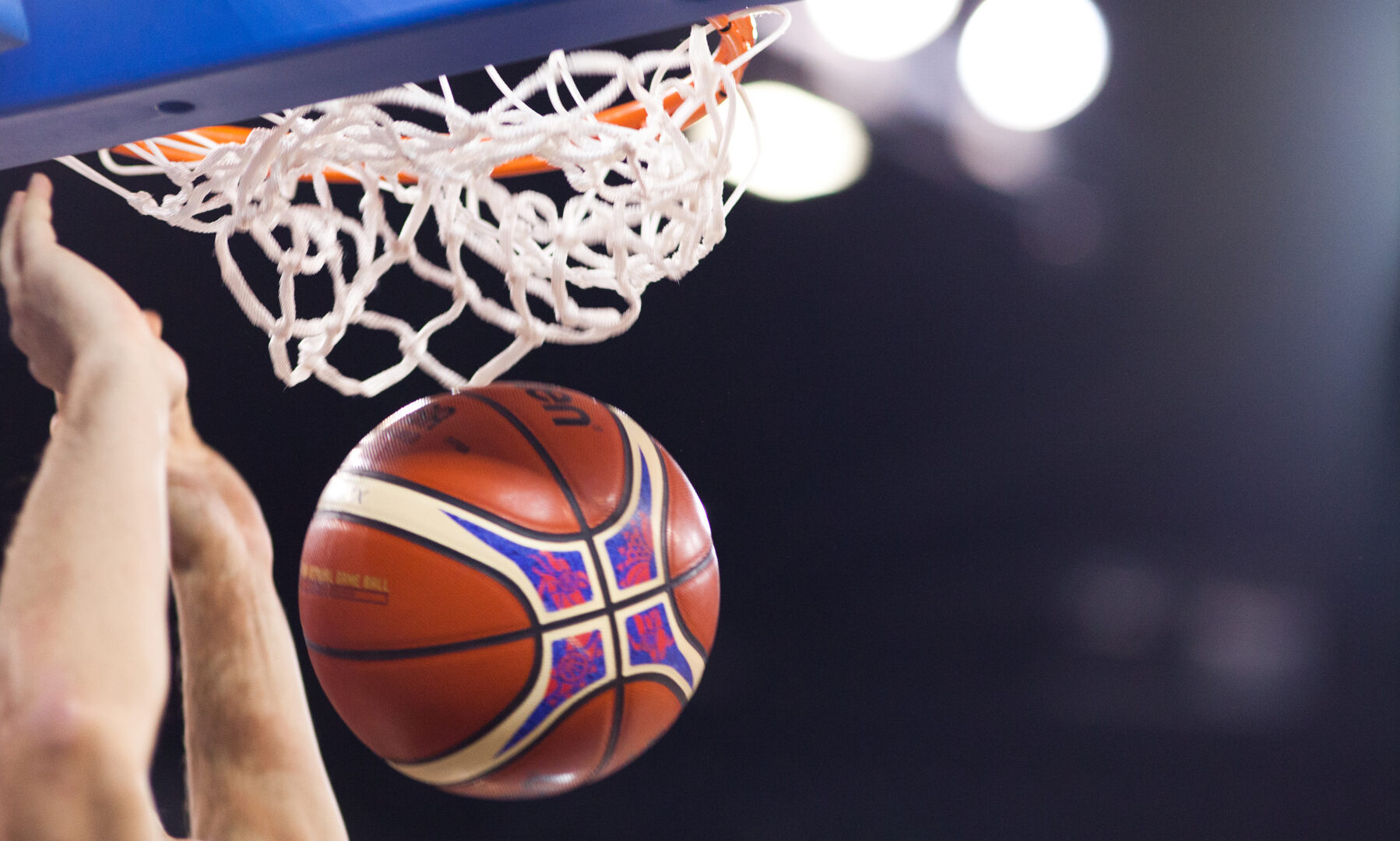 A basketball going through a hoop